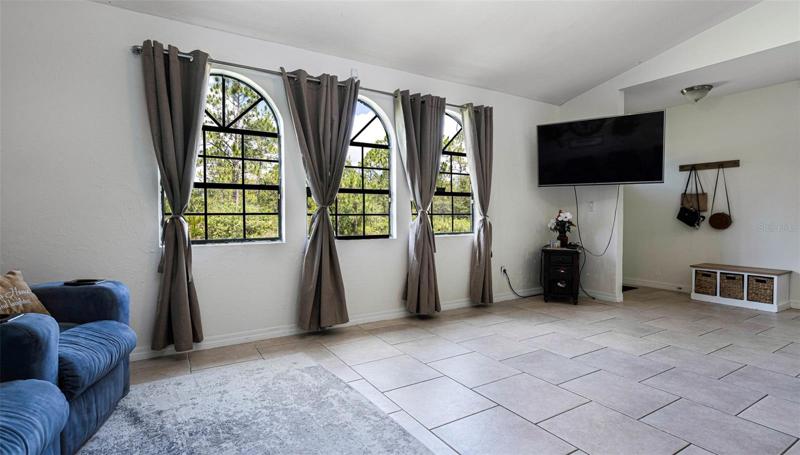 Foyer to right, this is the corner of the great room.  NOTE the beautiful tile which runs throughout the entire home!