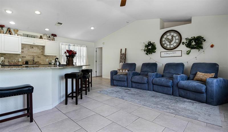 Great room looking to the central kitchen island and dine area. To your left is the large family room. Door in rear to the owner's suite.