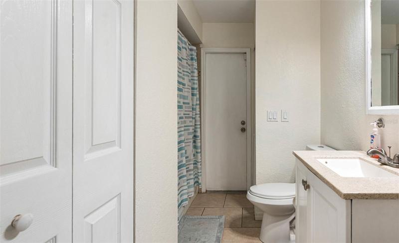 Far door is the pool bath entry for this guest bathroom