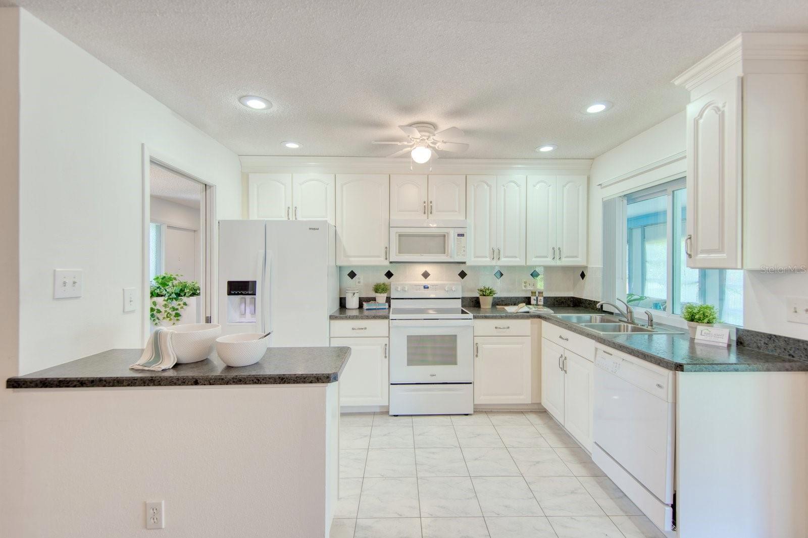 Renovated kitchen with opened wall, raised ceiling &amp; recessed lighting~