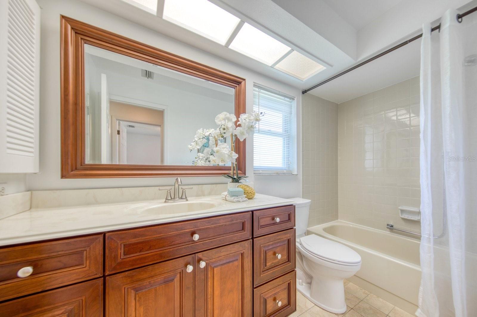 Guest bathroom also updated with large vanity cabinet with solid surface Corian counter~