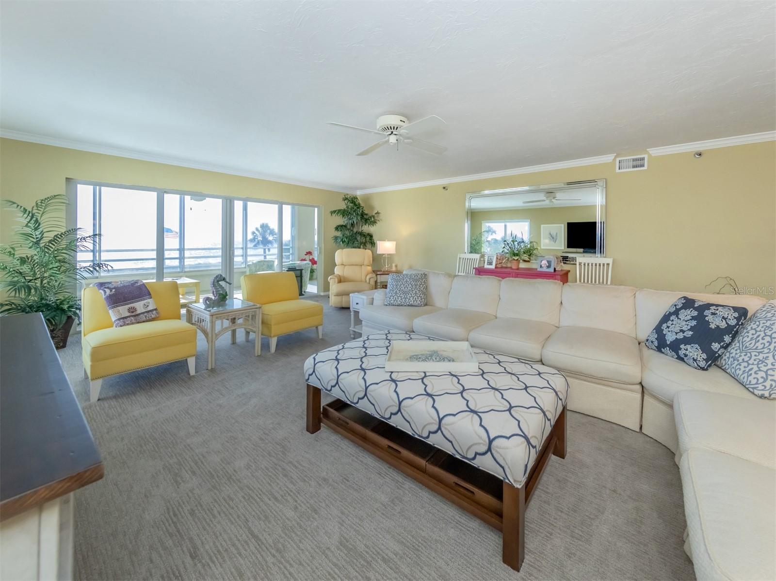 Living Room Brings In Captivating Views of the Beach and Gulf.