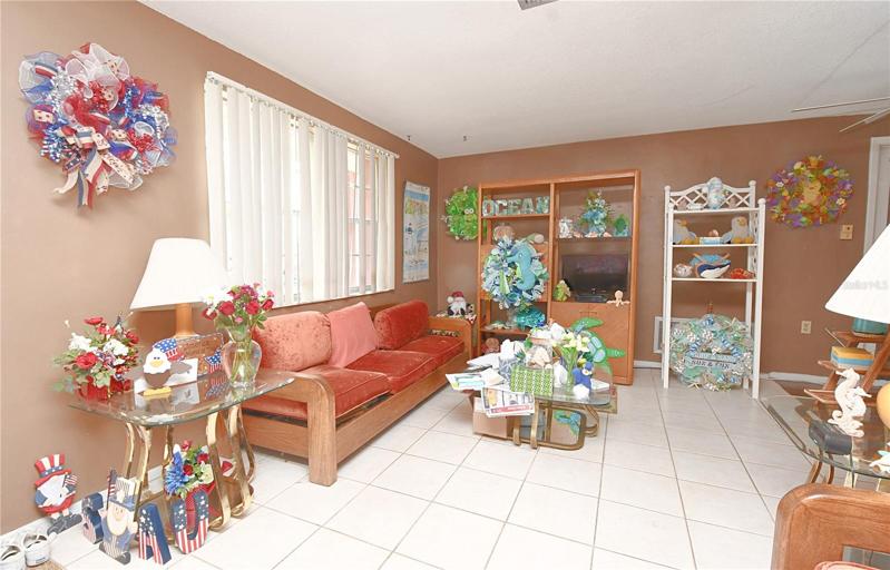 A picture window illuminates the living room with natural light.