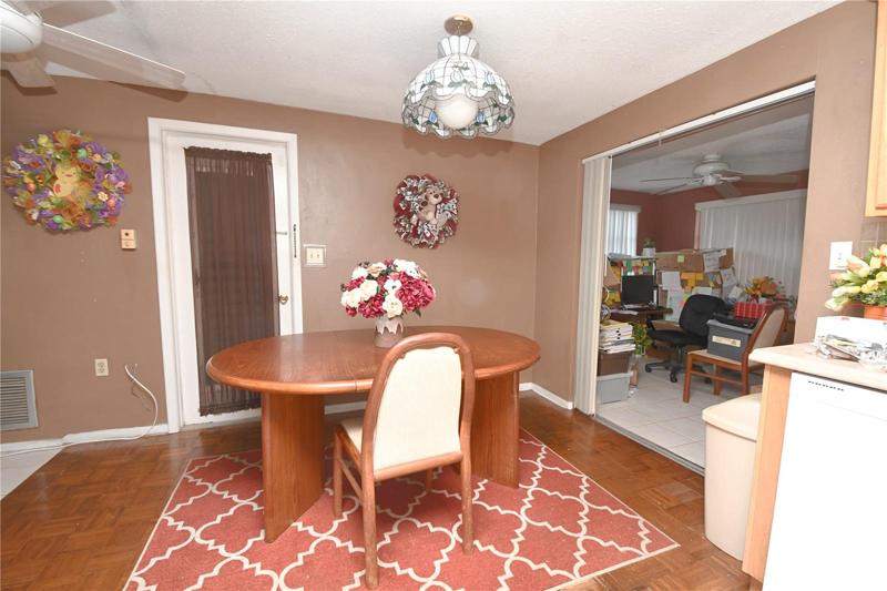The dining room opens to the kitchen and Florida room. The centerpiece is a tiffany inspired chandelier.