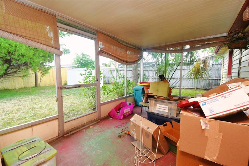 The screen in back porch looks out into the private back yard.