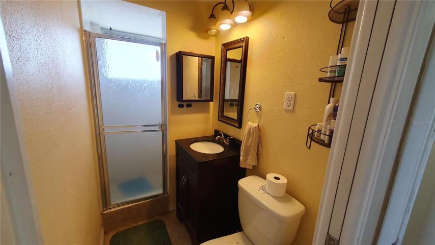Bedroom 2 has this private full bathroom with a step-in shower