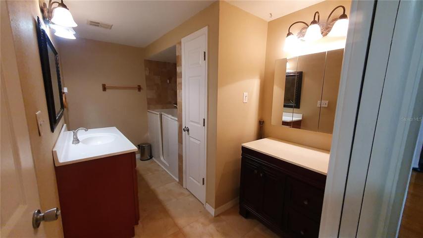 The common bathroom is accessible from hallway and bedroom 3. Bonus: walk-in tub!
