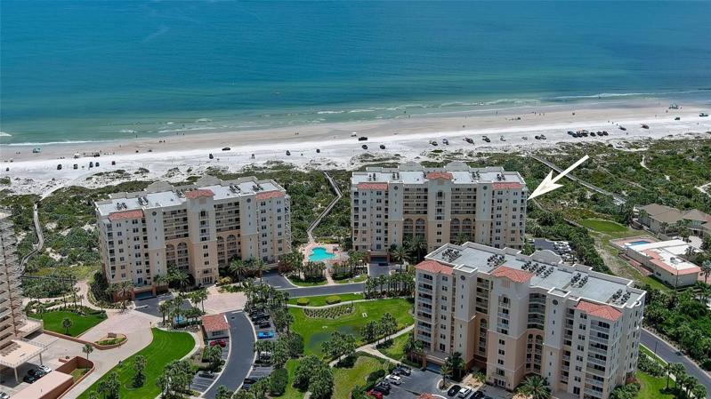 Direct oceanfront corner unit with SE exposure provides expansive views of the curvature of the beach!