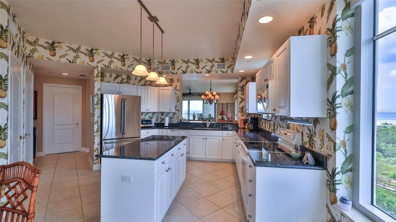 Gourmet kitchen with granite counters, 2 pantries, island & breakfast nook.