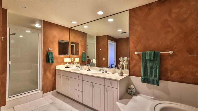 Double vanities & private toilet with linen closet.