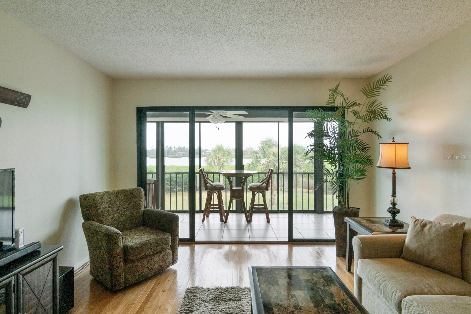 living room opens to the enclosed porch with water view