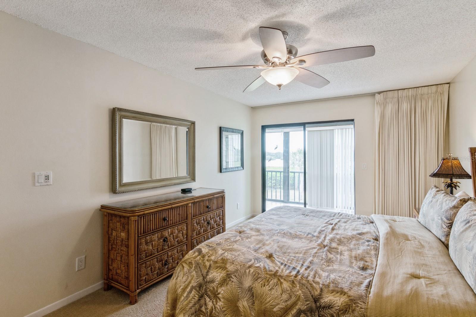 master bedroom opens to enclosed porch and water view