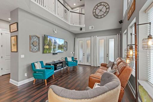 living room with double doors to the lanai.