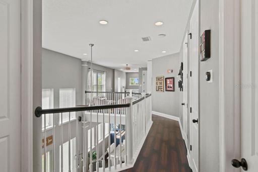 2nd floor hallway with views down to the living area.