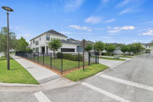 Large corner fenced in lot.