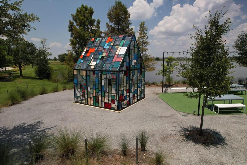 Artist Tom Fruin created “glass house” located in Laureate Park