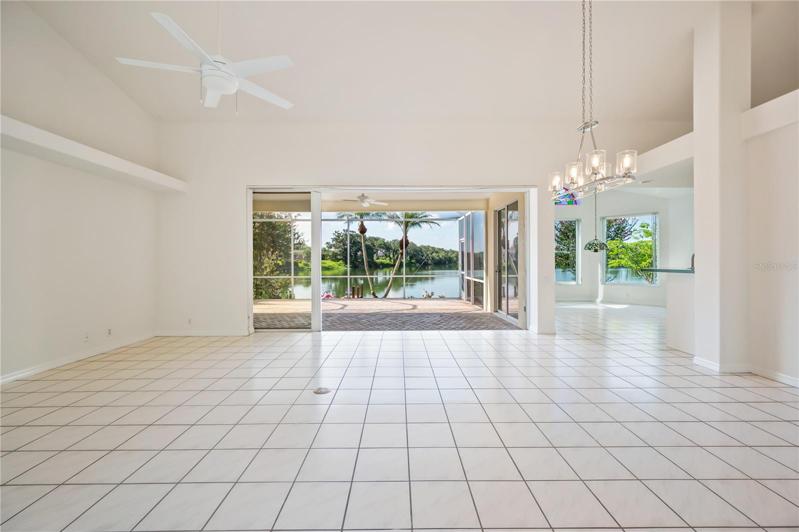 Upon entering,  your gaze sweeps thrught the Living Room/Dining. Room out to the screened lanai