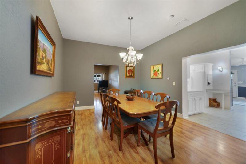 The dining area off the kitchen allows you to entertain with ease and the generous family room has a warm inviting color palette, easy care LAMINATE WOOD FLOORS and access to the expansive covered patio!