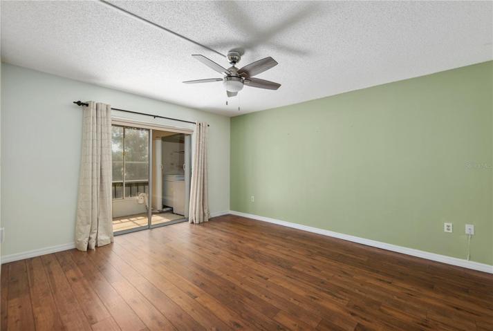 Master bedroom with sliding doors leading to the lanai and laundry area.