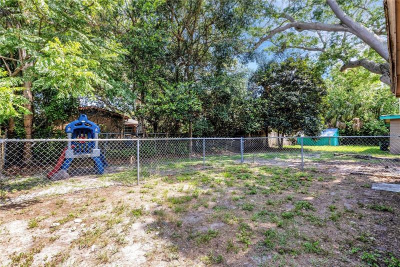 yard goes beyond chainlink to wood fence