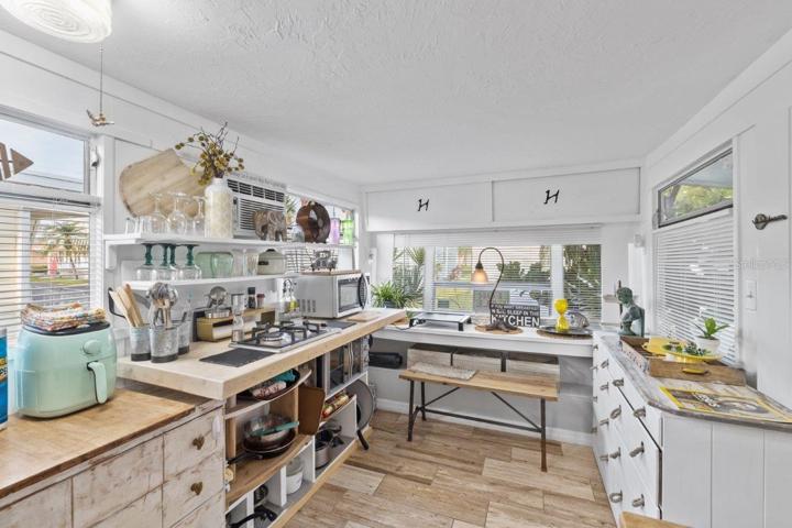 Kitchen featuring granite counter tops, gas stove, and wood look tile.