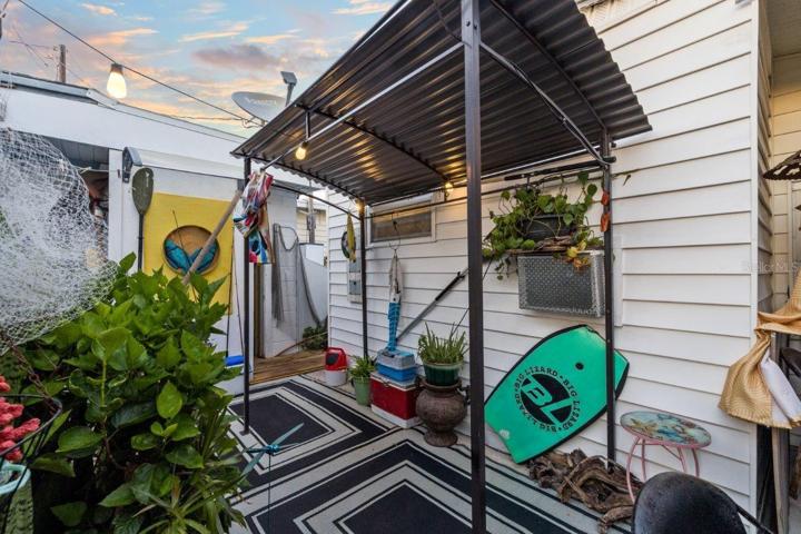 Back lanai featuring mature landscaping, and a outdoor full bathroom and laundry