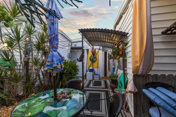Back lanai featuring mature landscaping, and a outdoor full bathroom and laundry