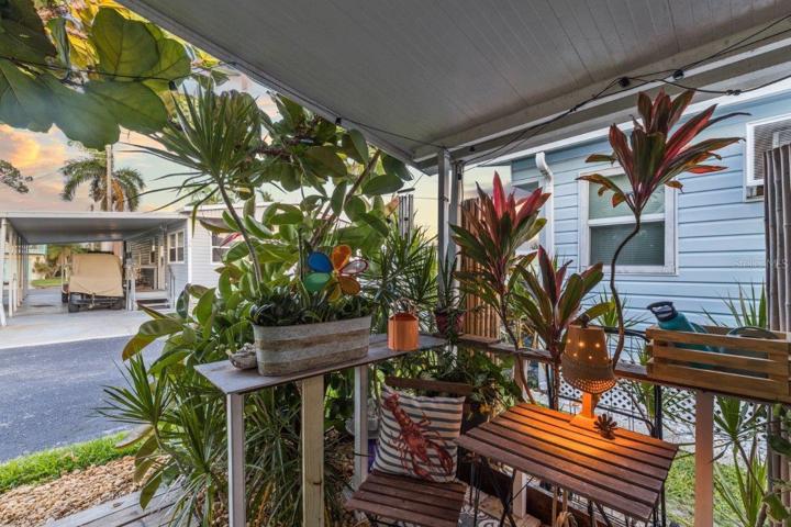 Front porch surrounded by mature landscaping