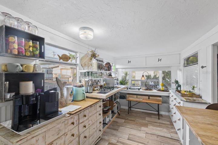 Kitchen featuring granite counter tops, gas stove, and wood look tile.