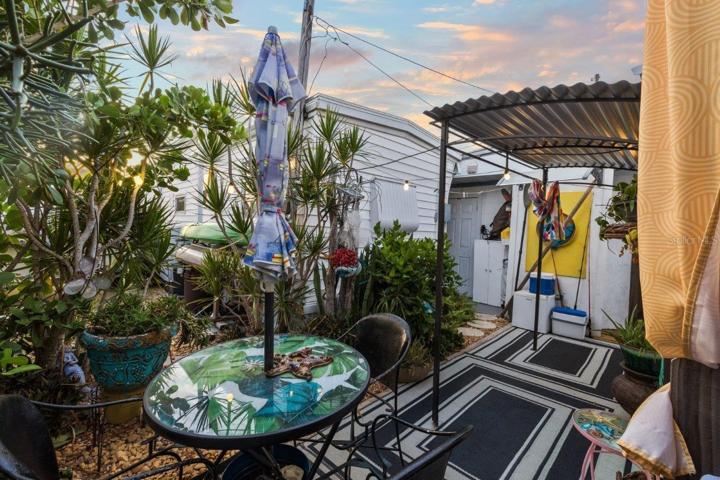 Back lanai featuring mature landscaping, and a outdoor full bathroom and laundry