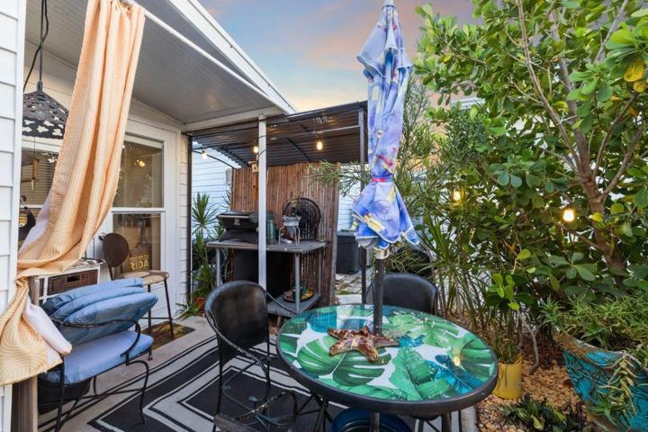 Back lanai featuring mature landscaping, and a outdoor full bathroom and laundry