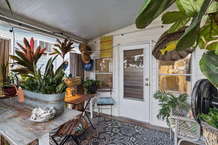 Front porch surrounded by mature landscaping