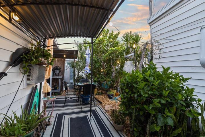 Back lanai featuring mature landscaping, and a outdoor full bathroom and laundry