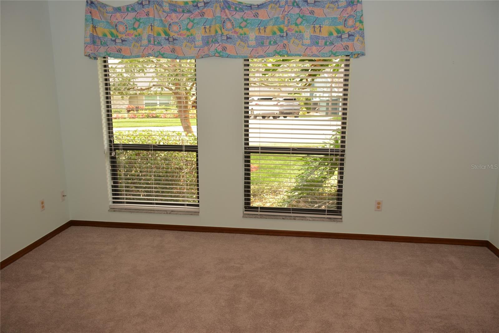 In the guest wing is the second bedroom with double windows for abundant natural light and a spacious walk-in closet with ample room for additional storage