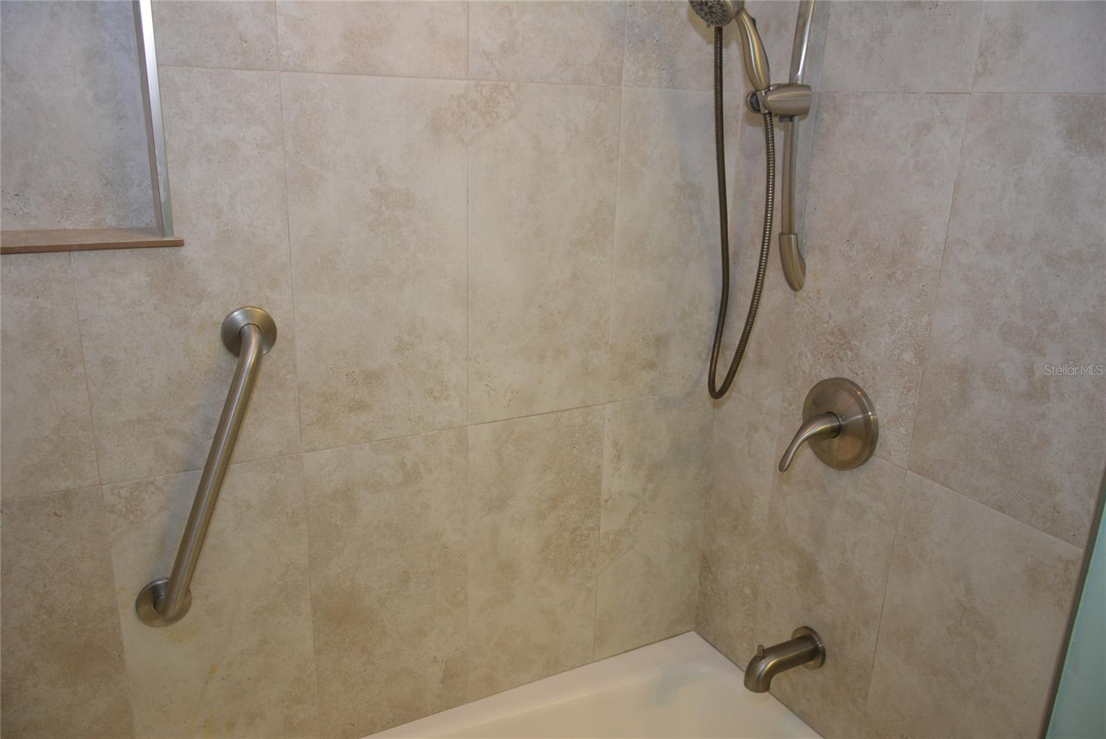 Combination shower/tub featuring an extra handheld showerhead