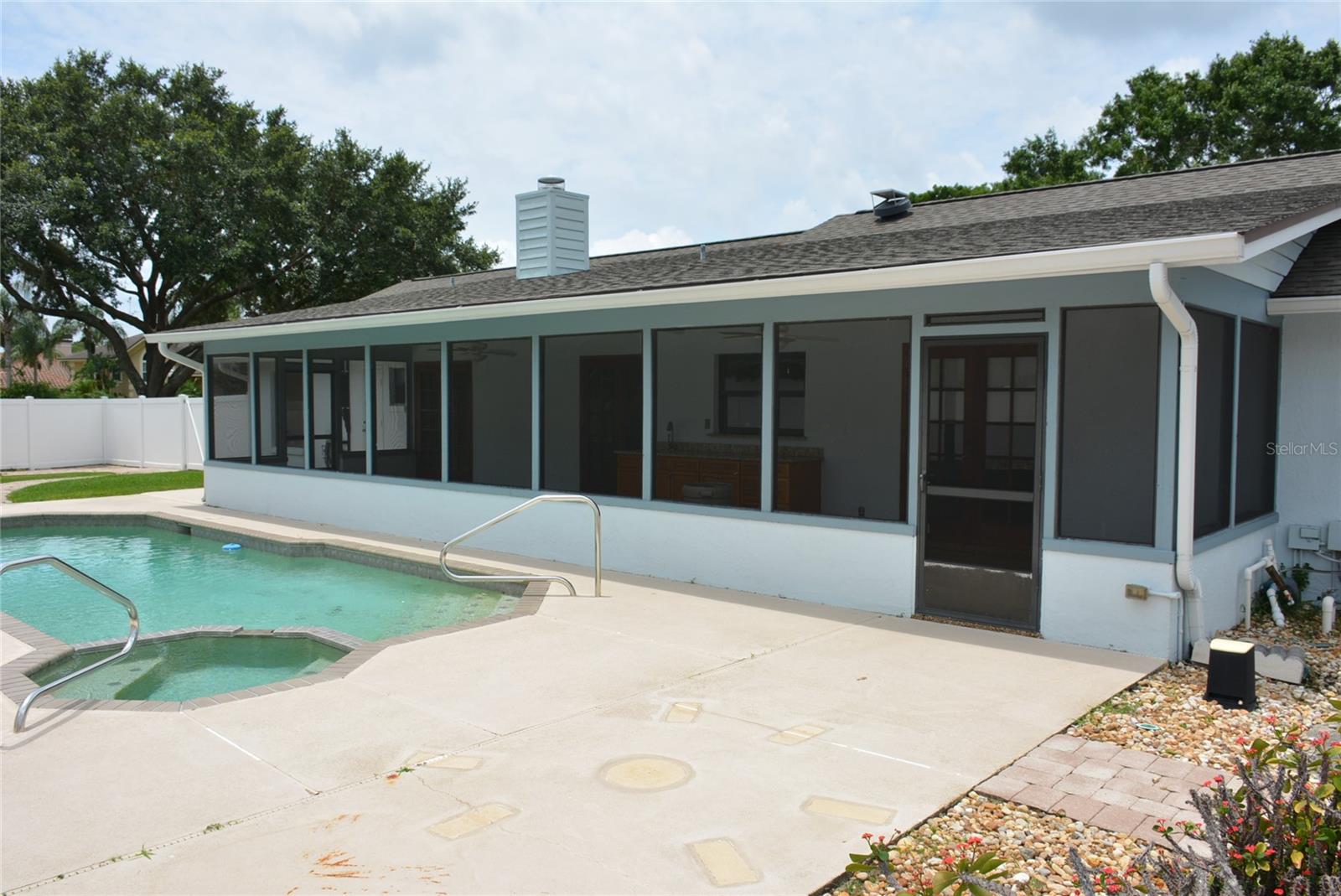 Extra-large (48’ x 10’) covered and screened lanai, overlooking the open pool, features an ample summer kitchen with built-in sink and pass through to the house kitchen