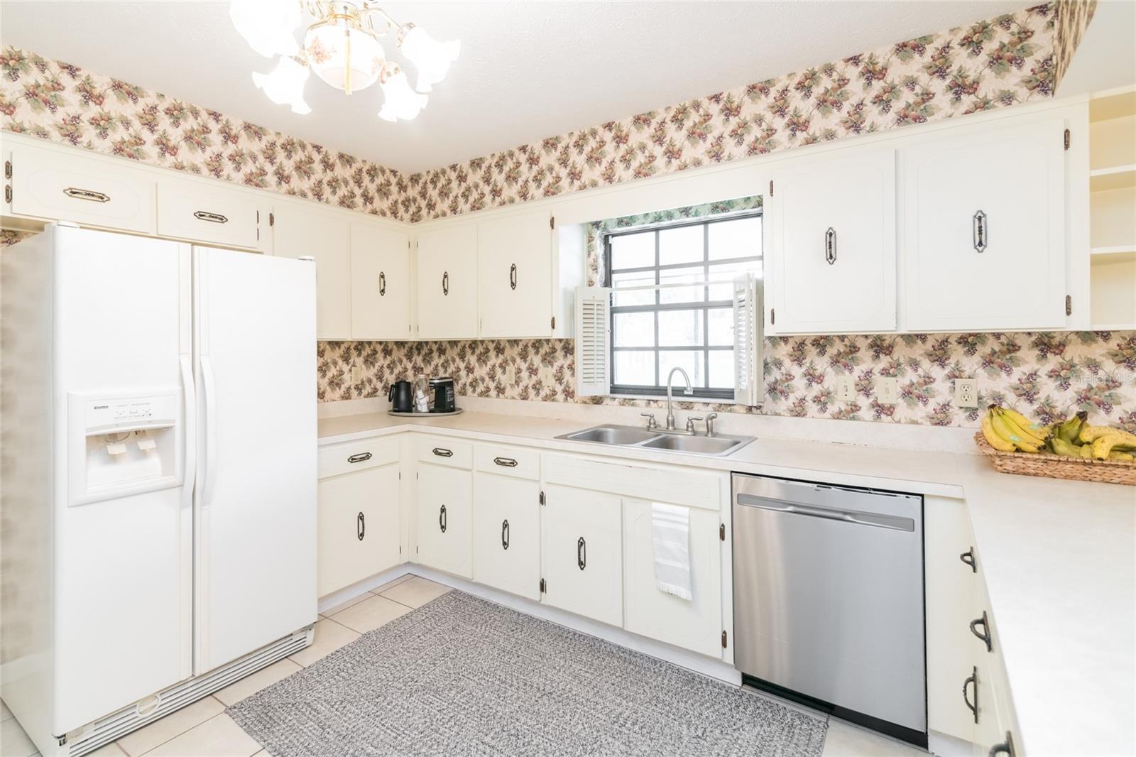 Large kitchen with tons of storage! View of the huge backyard.