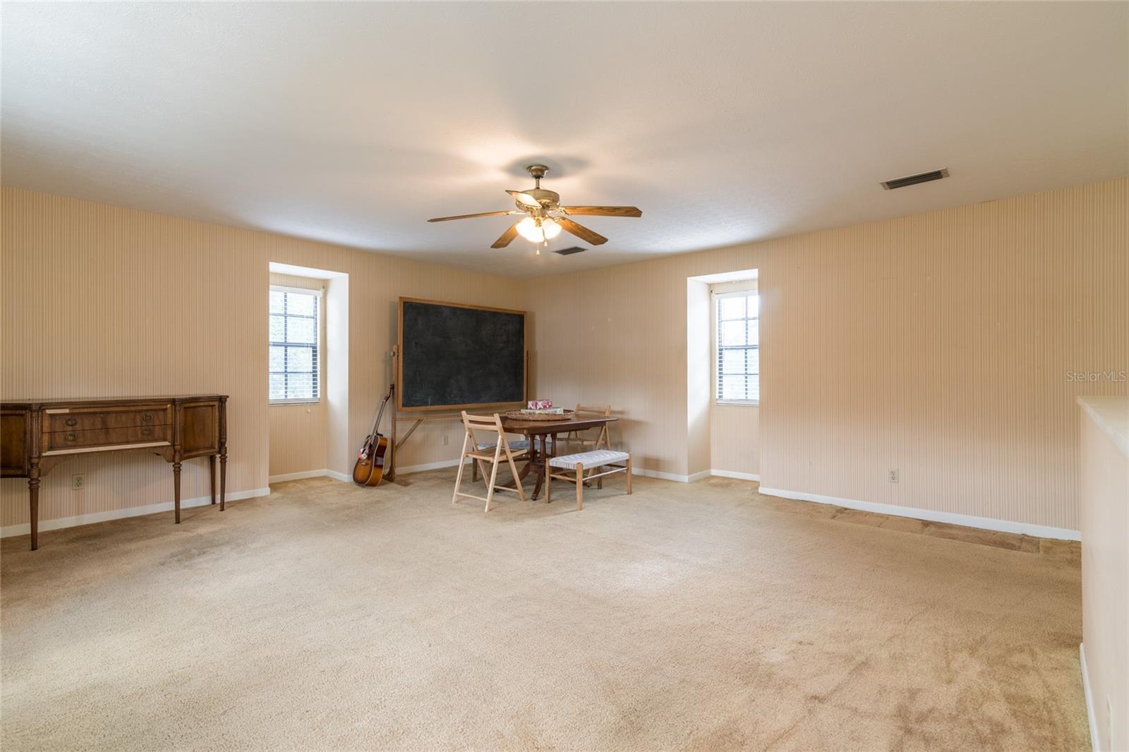Upstairs bonus room with private staircase. Would make great mother-in-law suite!