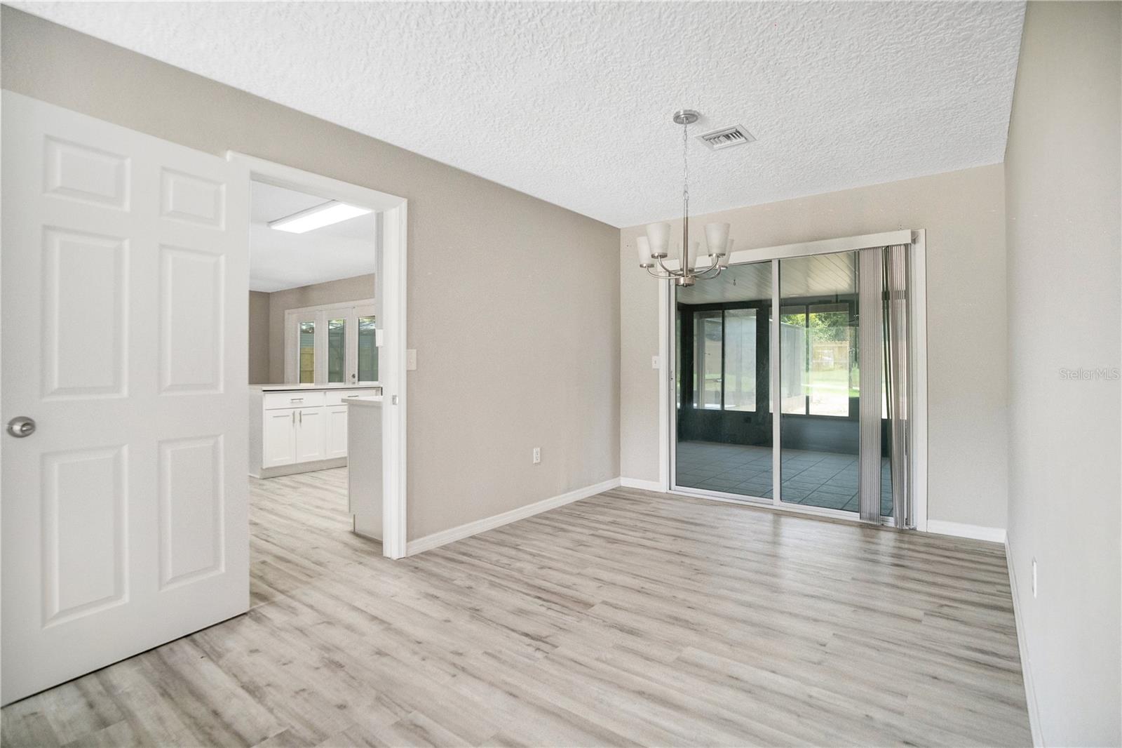 Formal dining room with access to the enclosed back porch.