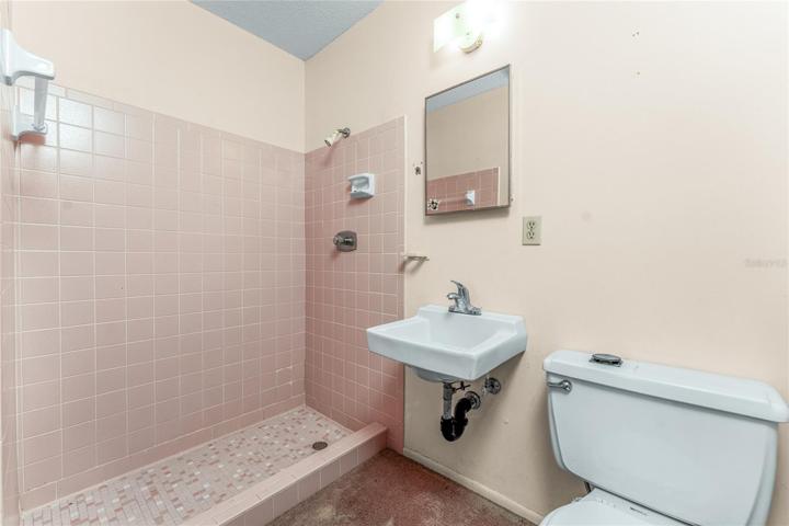 Guest bath has a step in shower.