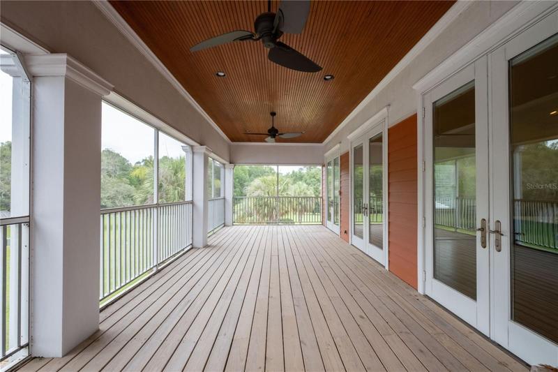 Upstairs owner's private screened patio overlooking the property