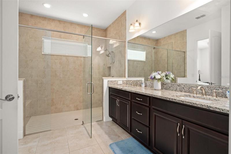 Oversized shower with built-in bench seating.
