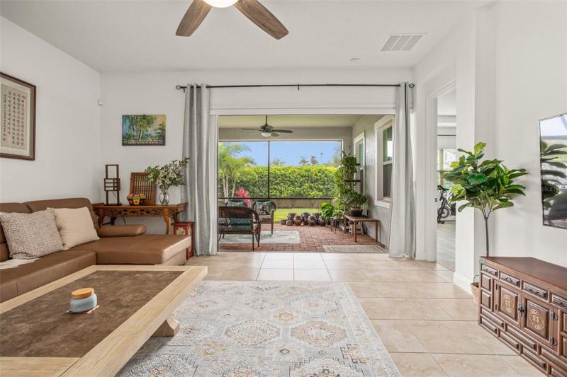 Enjoy the indoor-outdoor feel of the screened lanai with disappearing glass sliding doors.