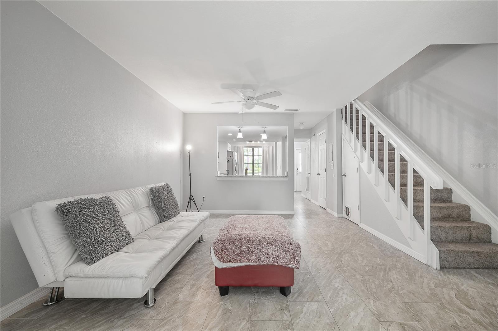 Living room features a wood burning fireplace and easy tile floors
