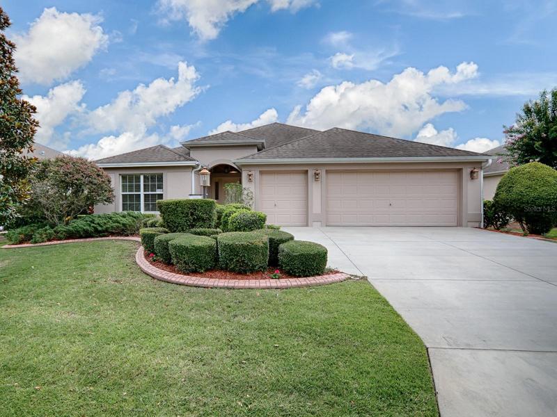 LOVELY 3/2 IRIS DESIGNER HOME WITH 2 CAR + GOLF CART GARAGE IN THE VILLAGE OF BUTTONWOOD!