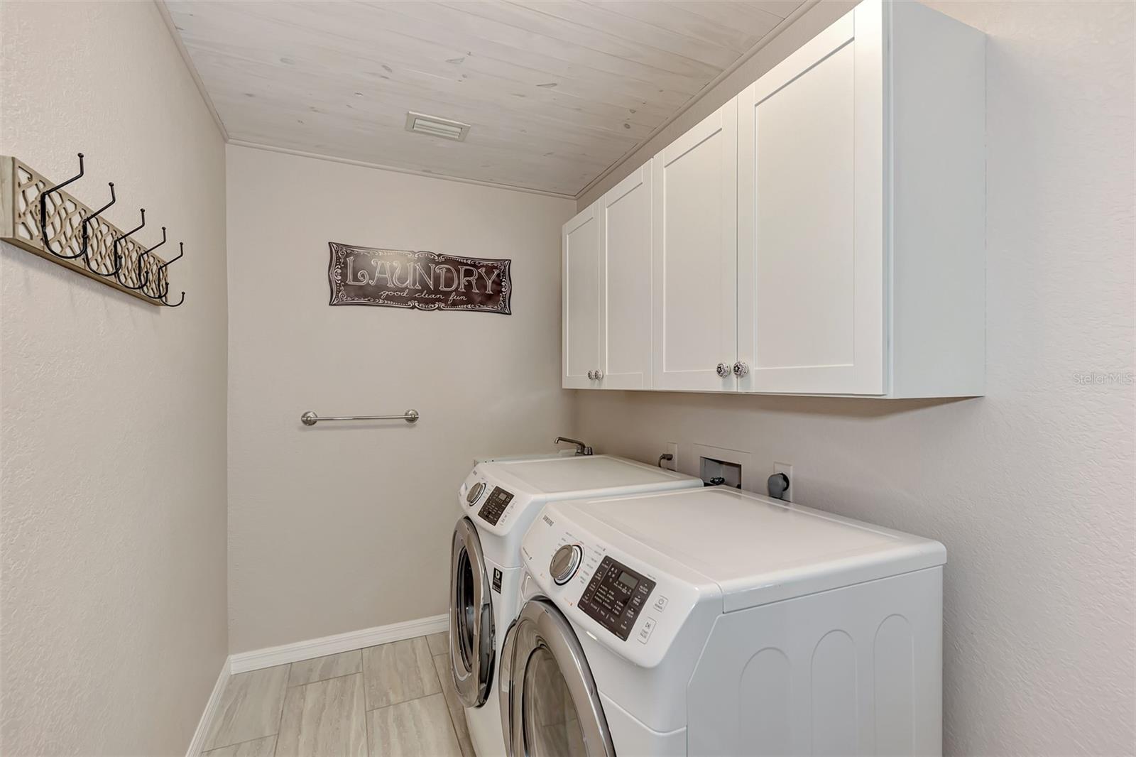The laundry room features a convenient wash tub