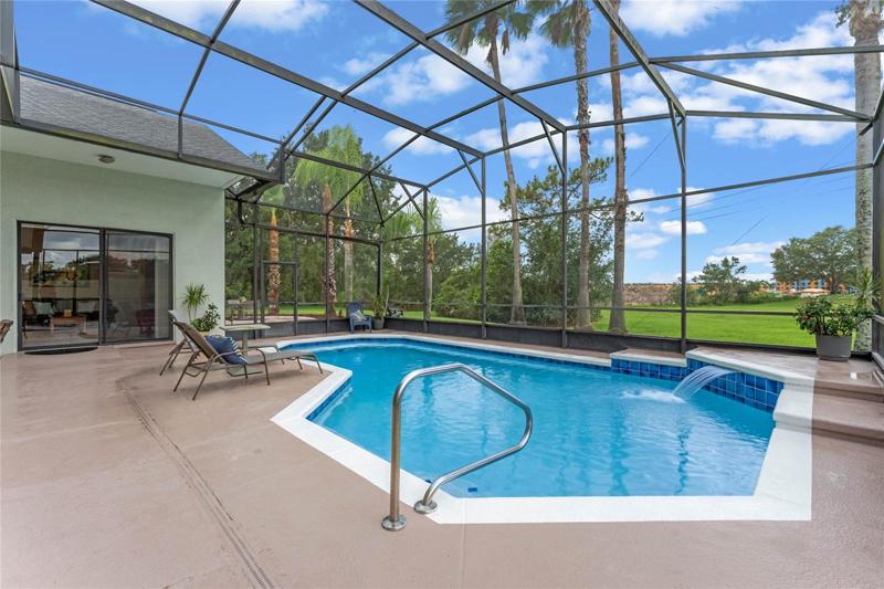 Screened in pool with water feature