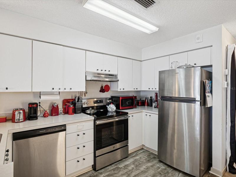 The Kitchen features a Dishwasher, Stove Microwave, Refrigerator and pleanty of Storage