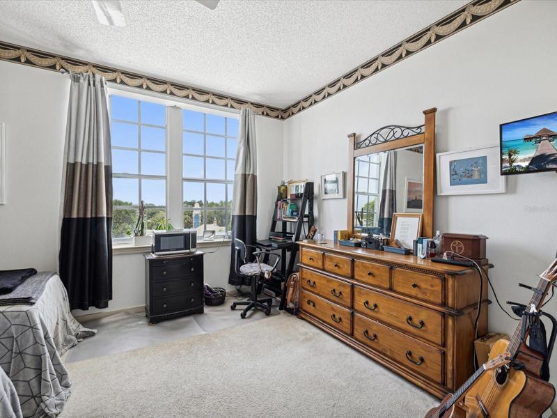 Large Master Bedroom has tons of light shining through the windows