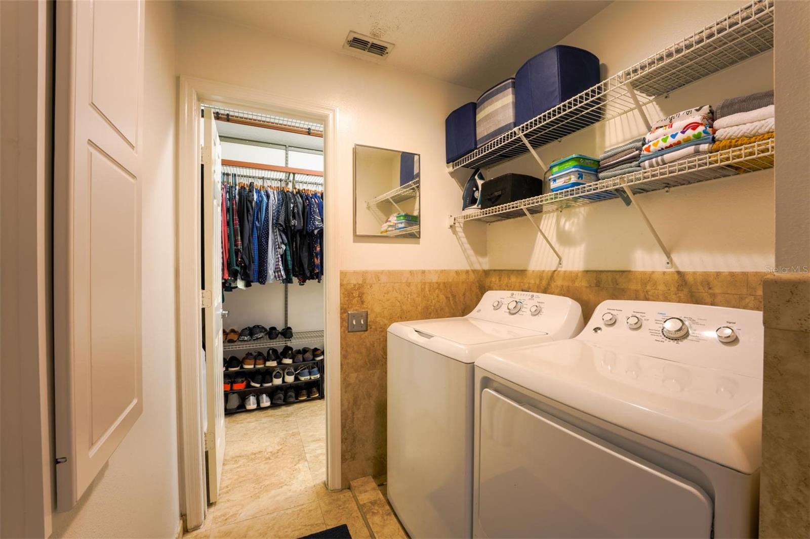 Upstairs laundry room, connecting to primary closet